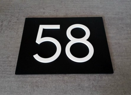 Mat zwart huisnummerbord met witte cijfers